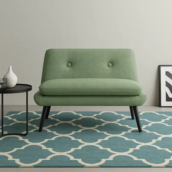 A green upholstered armless accent chair with button tufting and dark wood legs.